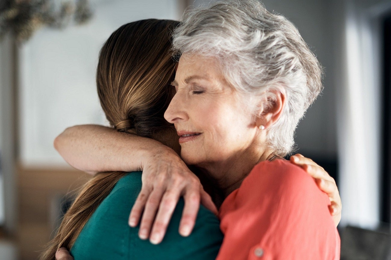 Senior Woman Hugging her Caregiver