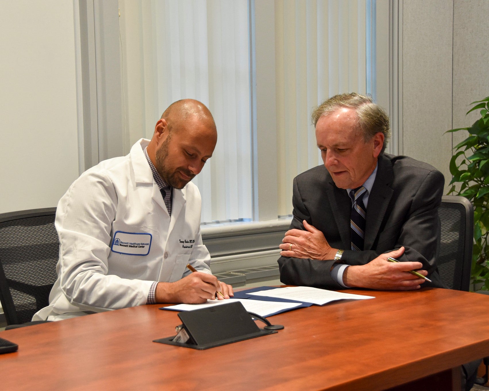Dr. Ibrahim Signing Contract Extension with Doug Hastings