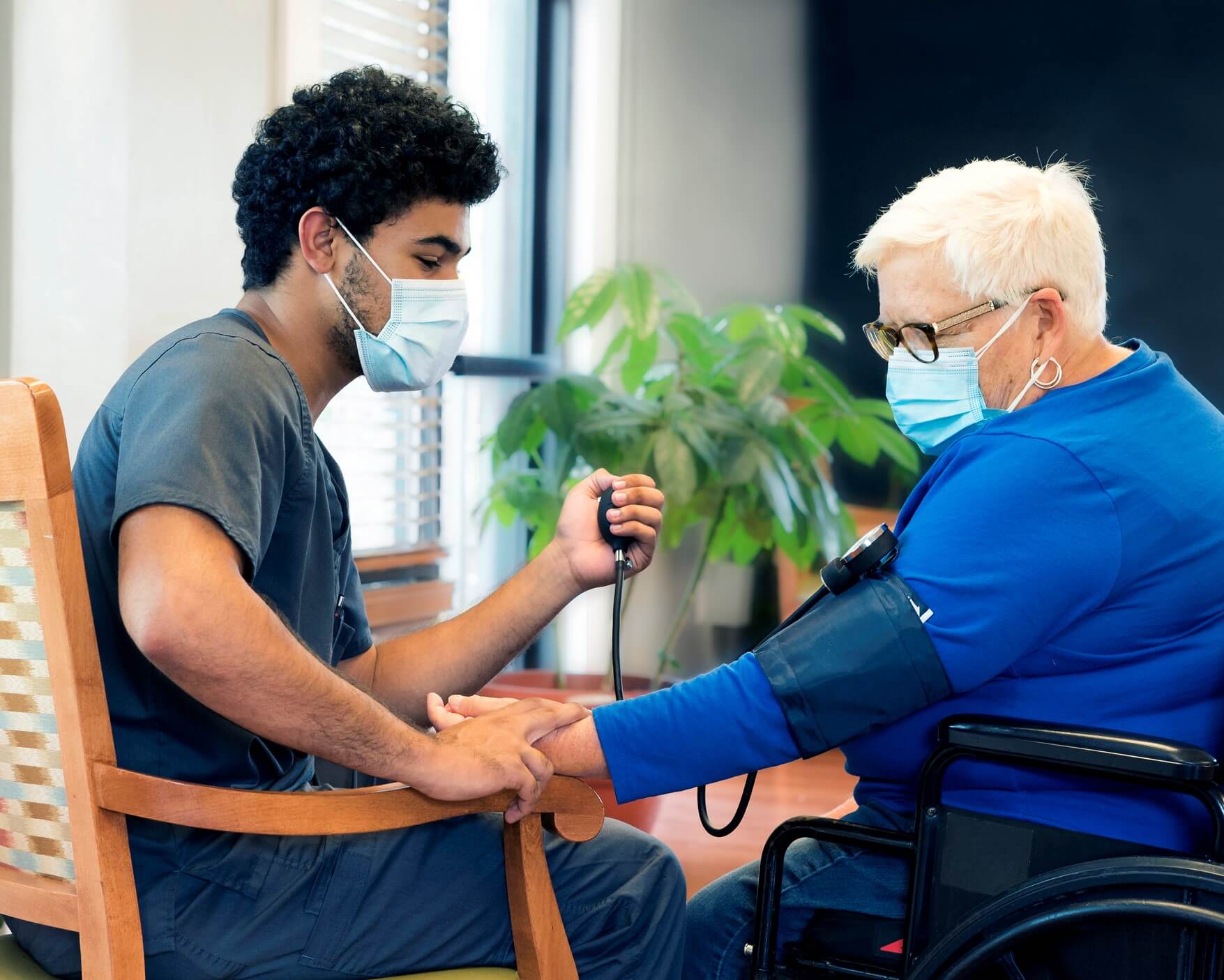 VHS CNA taking blood pressure of a nursing home resident
