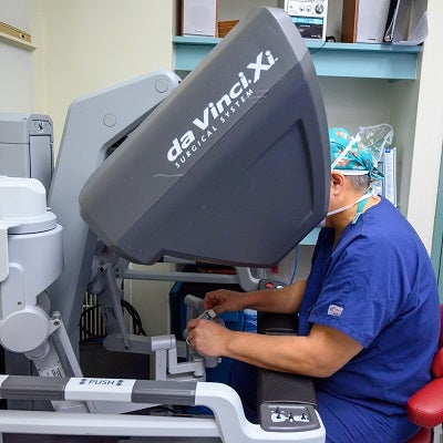 Dr. Luis Oceguera operates the da Vinci robot arms to perform hernia surgery