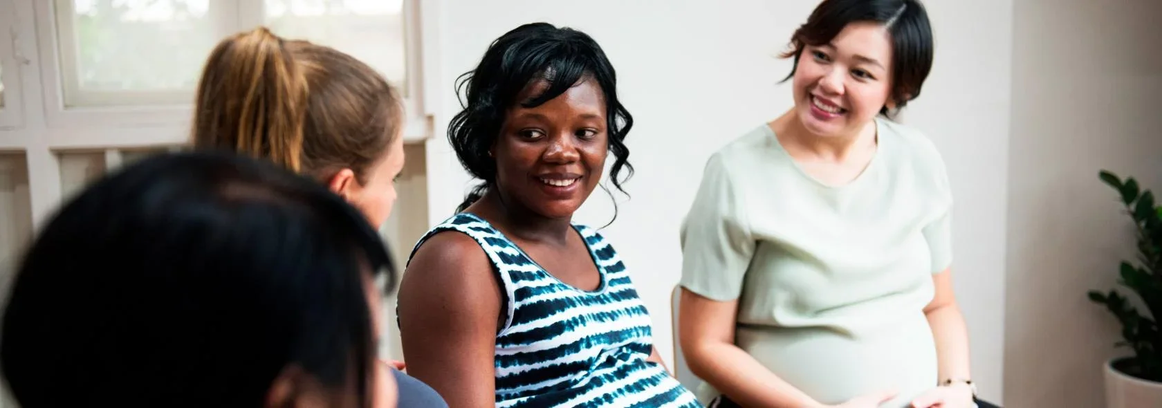 A group of women conversing with one another