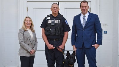 David & Susan Theobald posing with Officer Bever & K-9 Hutch