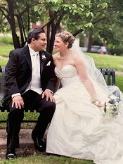 Stephanie and Luis sitting on a bench on their wedding day