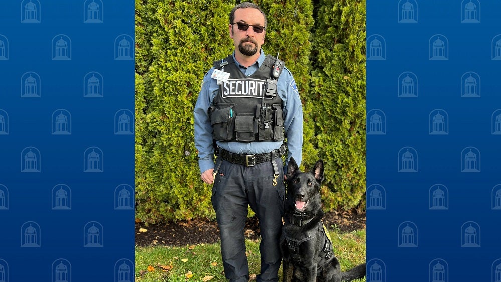 Officer Ryan Salisbury poses with K-9 Coal