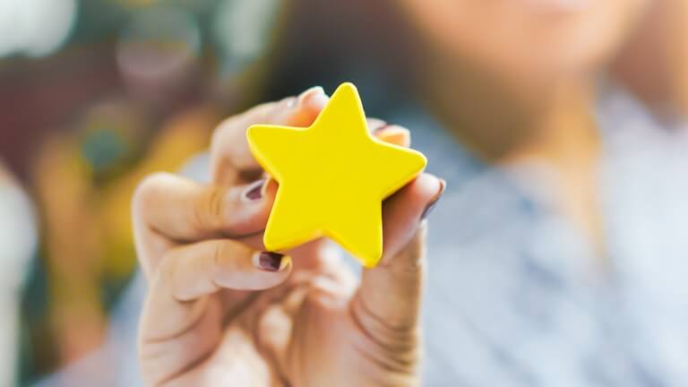 Woman holding up a star