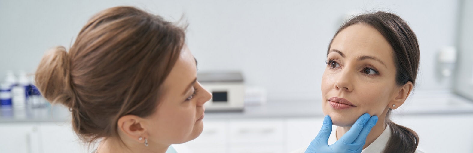 Dermatologist examining a patient