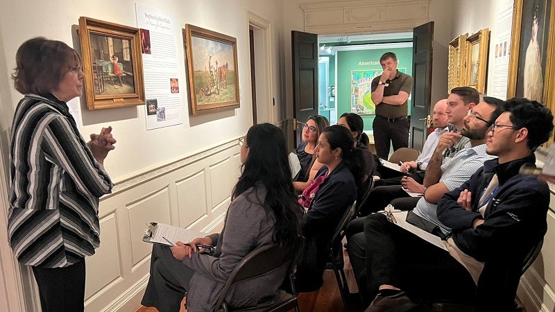 Residents observing a painting and discussing it with Laura Wetzel