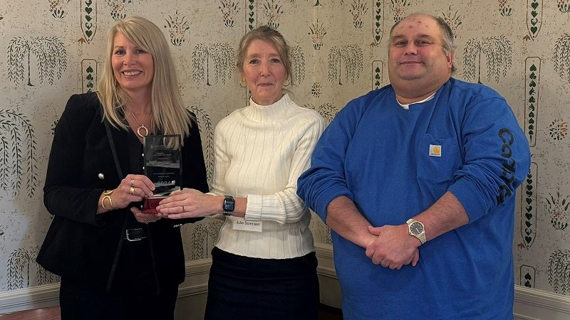 Tonya Van Slyke of the Northeast Dairy Producers Association (left) receives the 2024 Hero Award from NYCAMH Director Dr. Julie Sorensen and ROPS Hotline Coordinator Duane Martin.