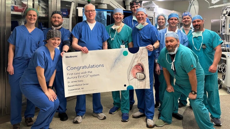 Dr. James Storey, nurses, technicians and other healthcare providers who assisted with Bassett Medical Center’s first case with the Medtronic EV-ICD system take a photo with a celebratory banner.  