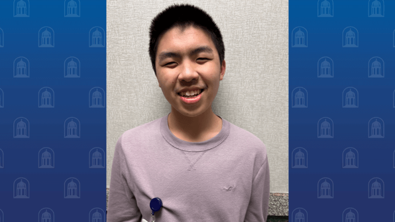 A young man smiles for the camera. 