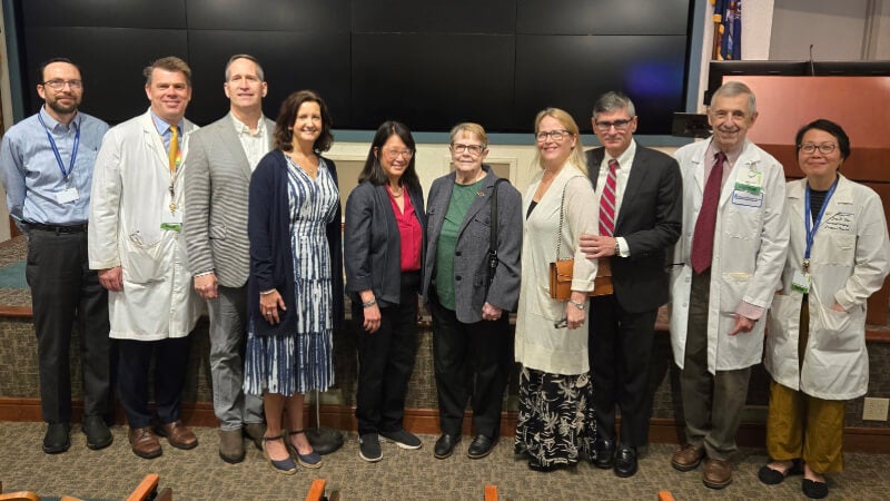 10 people pose for a photo.