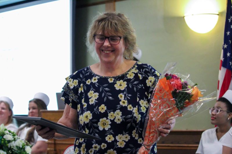 Laura Palada, RN, BSN, MSHCA, Director of Quality at Bassett Healthcare Network and an LPN Program Instructor, accepts a student-nominated teaching award. 