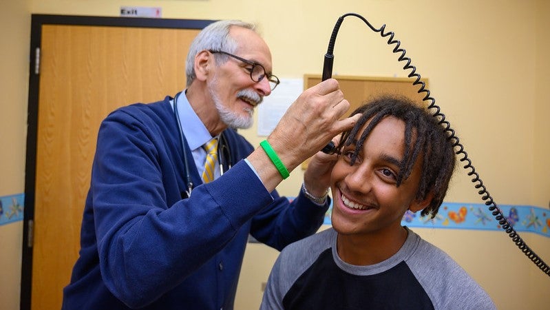 Dr. Kjolhede examines a student at a School-Based Health Center