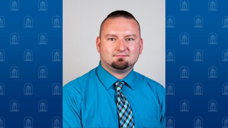 A man wearing a shirt and tie is photographed. 