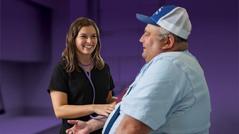 Bassett nurse taking a patient's blood pressure