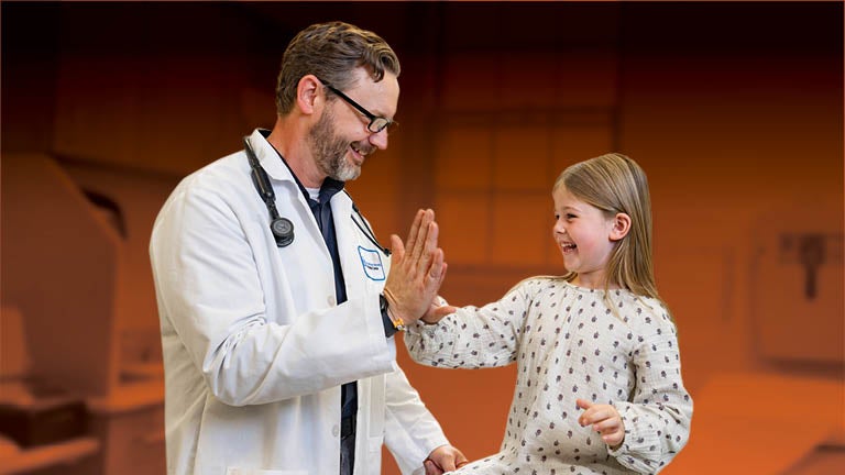 Bassett physician high-fiving child patient