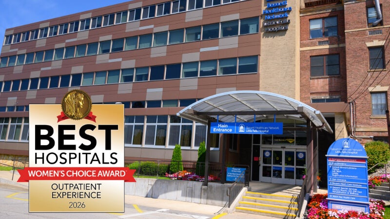 Seal announcing Little Falls Hospital as one of the Best Hospitals for Outpatient Experience in 2026 is positioned on a photo of the exterior of the hospital building. 