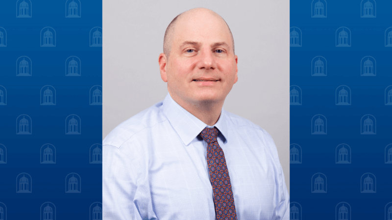A man, Dr. Evan Adelstein, is photographed. He is wearing professional attire.
