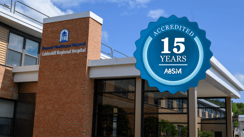 A photo of Cobleskill Regional Hospital has a seal edited onto it that reads "Accredited 15 Years AASM"