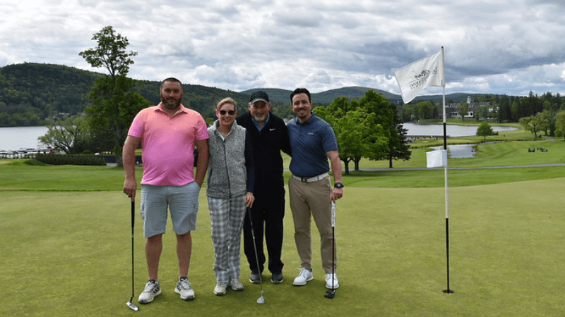 Four golfers stand together on The Otesaga Hotel’s Leatherstocking Golf Course.