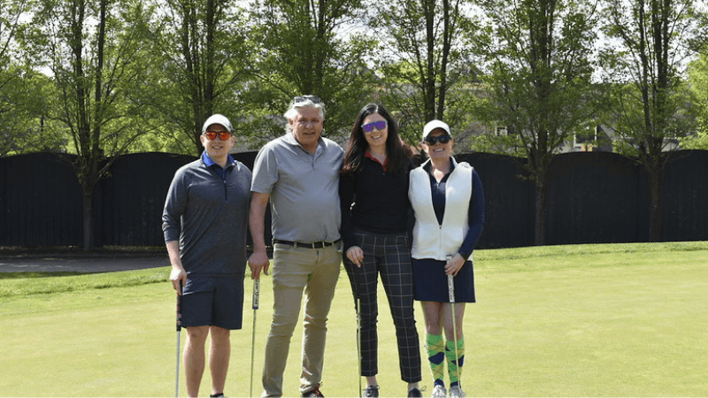 Four golfers stand together on The Otesaga Hotel’s Leatherstocking Golf Course.