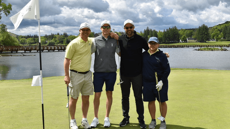 Four golfers stand together on The Otesaga Hotel’s Leatherstocking Golf Course.