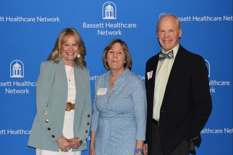  Three people stand side by side in front of a Bassett Healthcare Network backdrop.