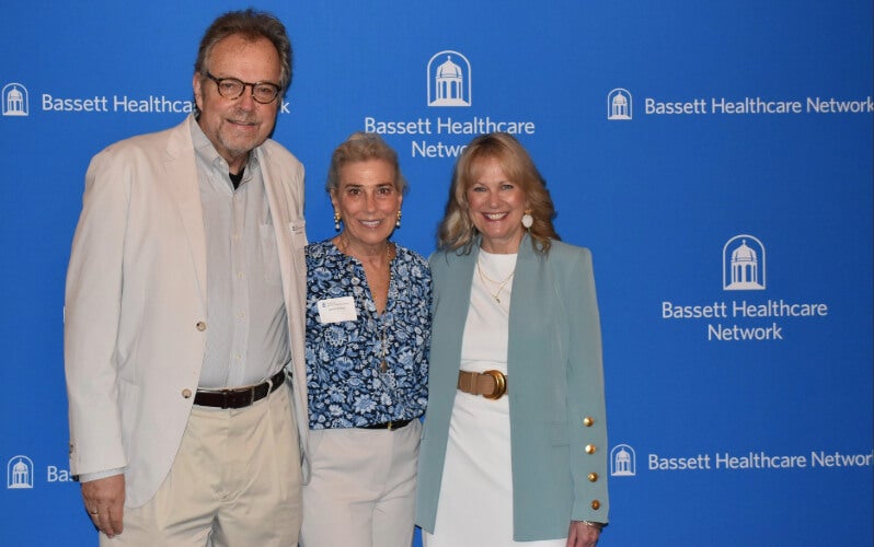 Three people stand side by side in front of a Bassett Healthcare Network backdrop.