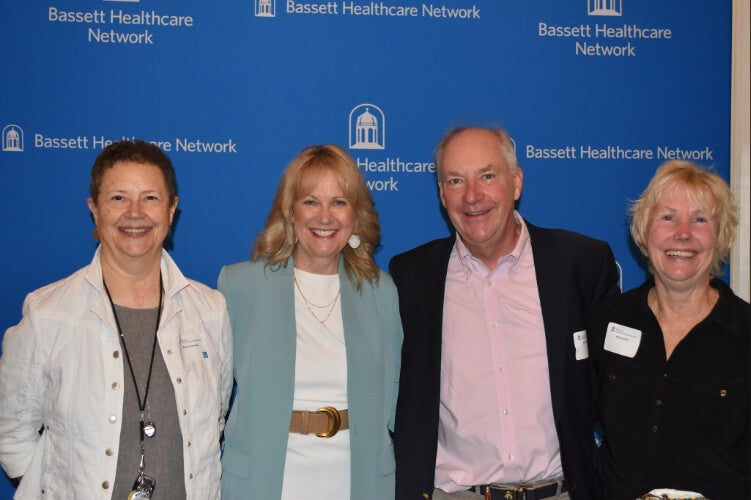 Four people stand side by side in front of a Bassett Healthcare Network backdrop.