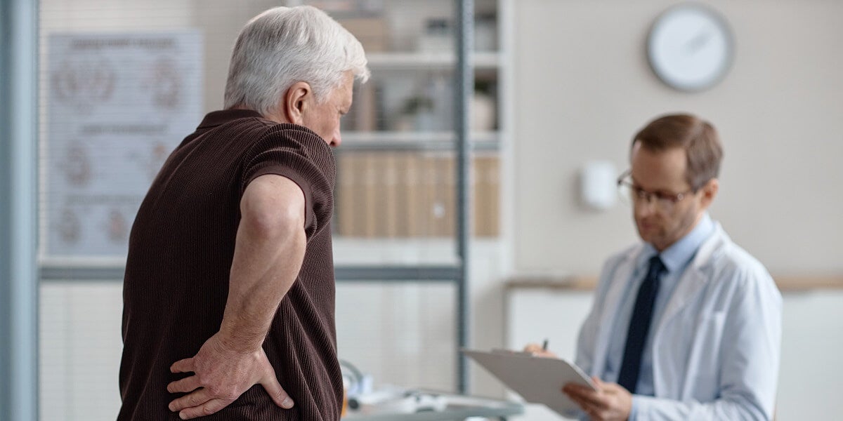 Urologist examining an elderly male patient