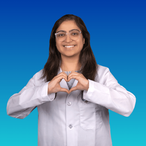 Doctor in white coat making a heart shape with hands