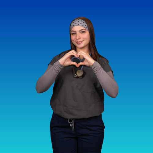 a woman in nursing scrubs making a heart shape with hands