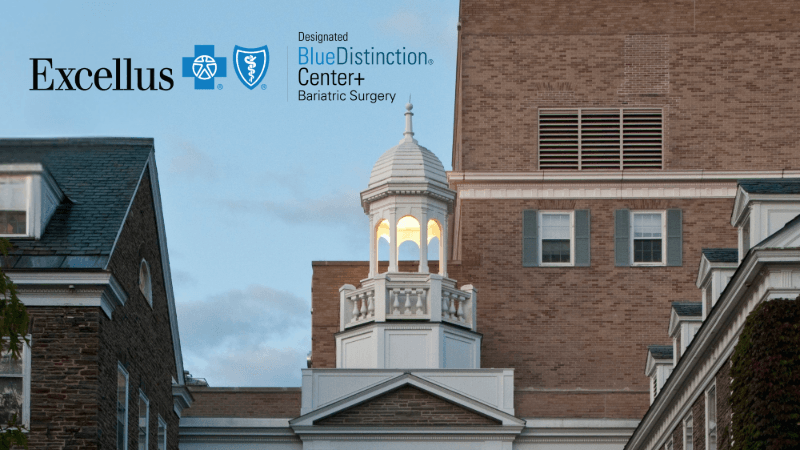A photo of the lit cupola that sits on top of Bassett Medical Center. A seal is edited on to the photo that reads Excellus Designated BlueDistinction Center+ Bariatric Surgery. 