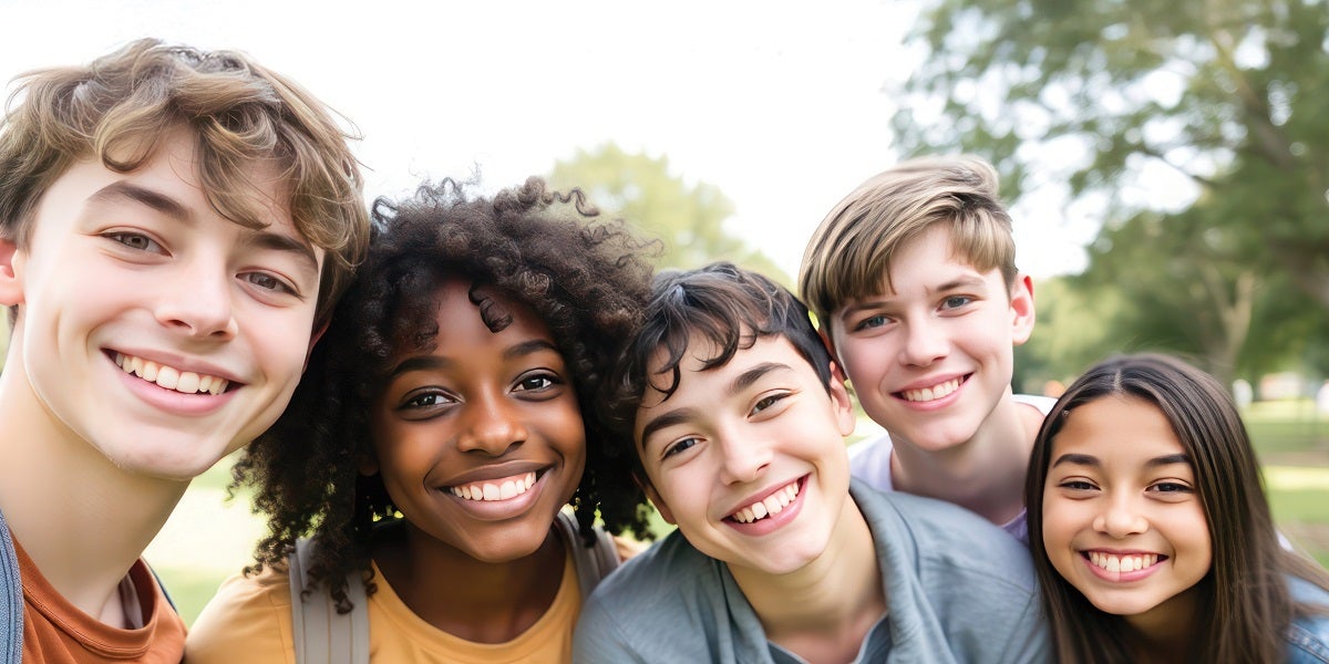 Pre-teen children standing together, smiling