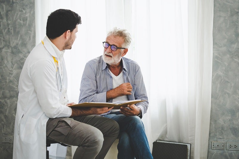 speech therapy doctor having a session with an older male patient