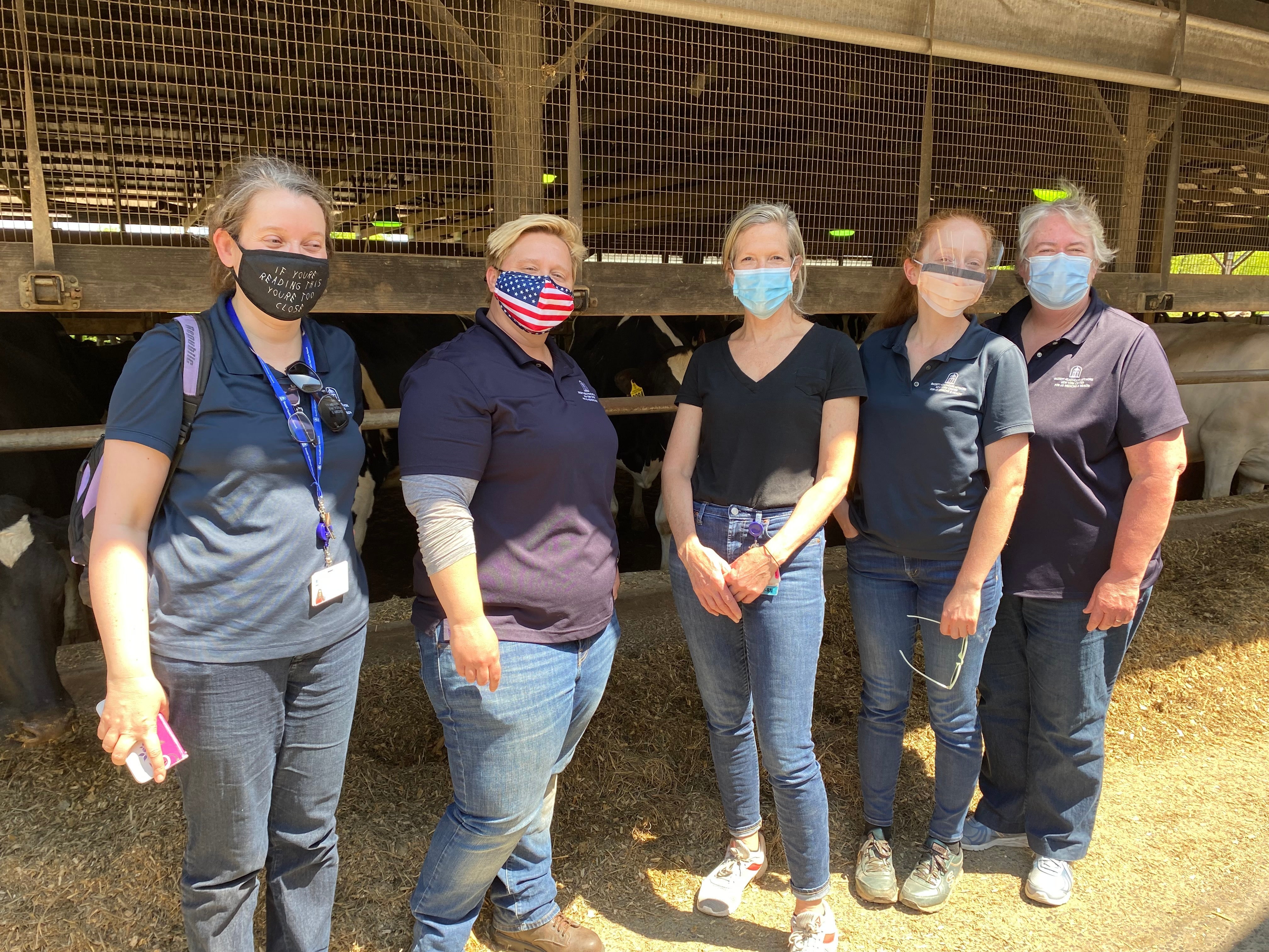 Cristina Hansen Ruiz, Nicole Blanchard, Judy Graham, Anna Meyerhoff, and Susan Ackerman, by a corn crib.