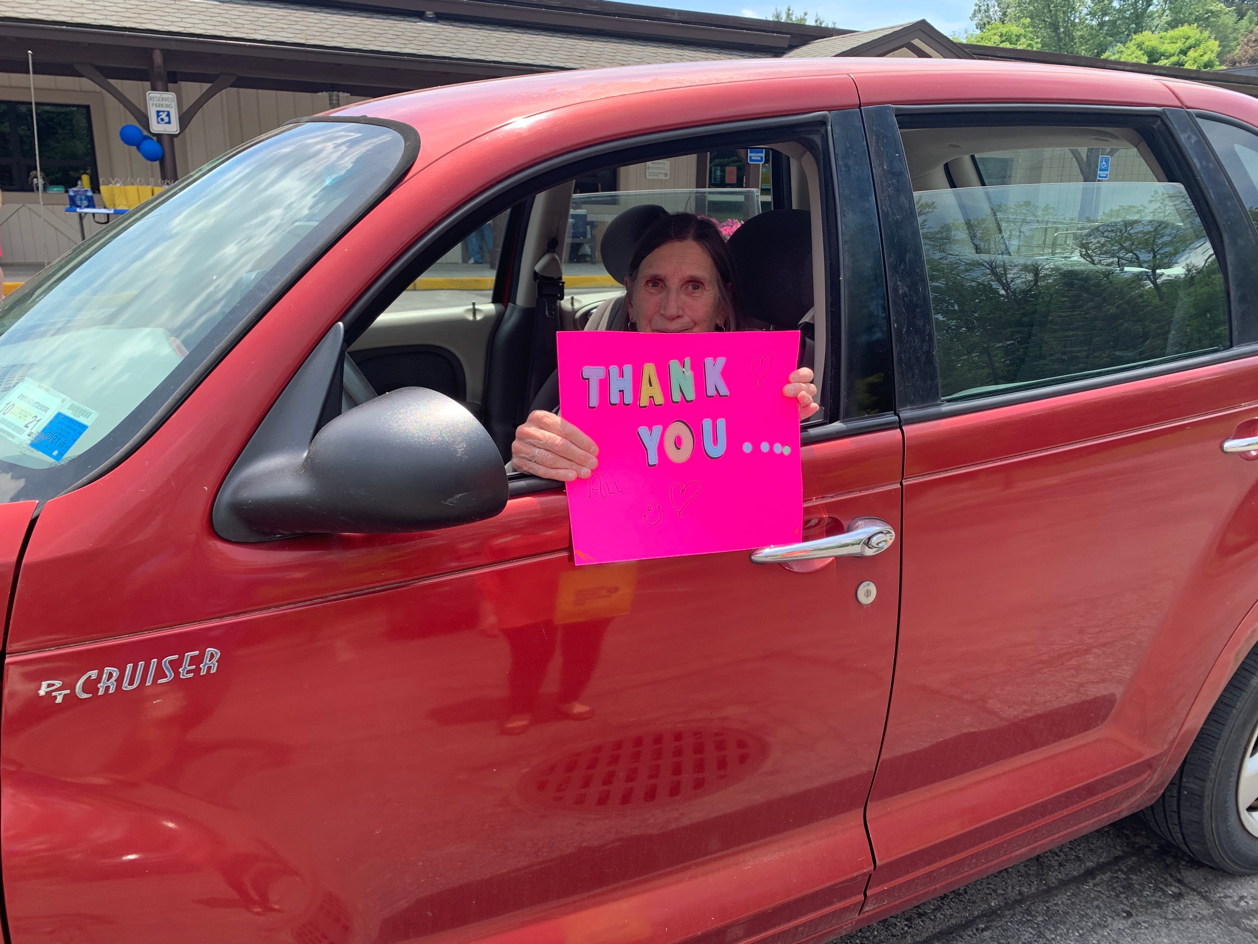 Patient with thank you sign at event