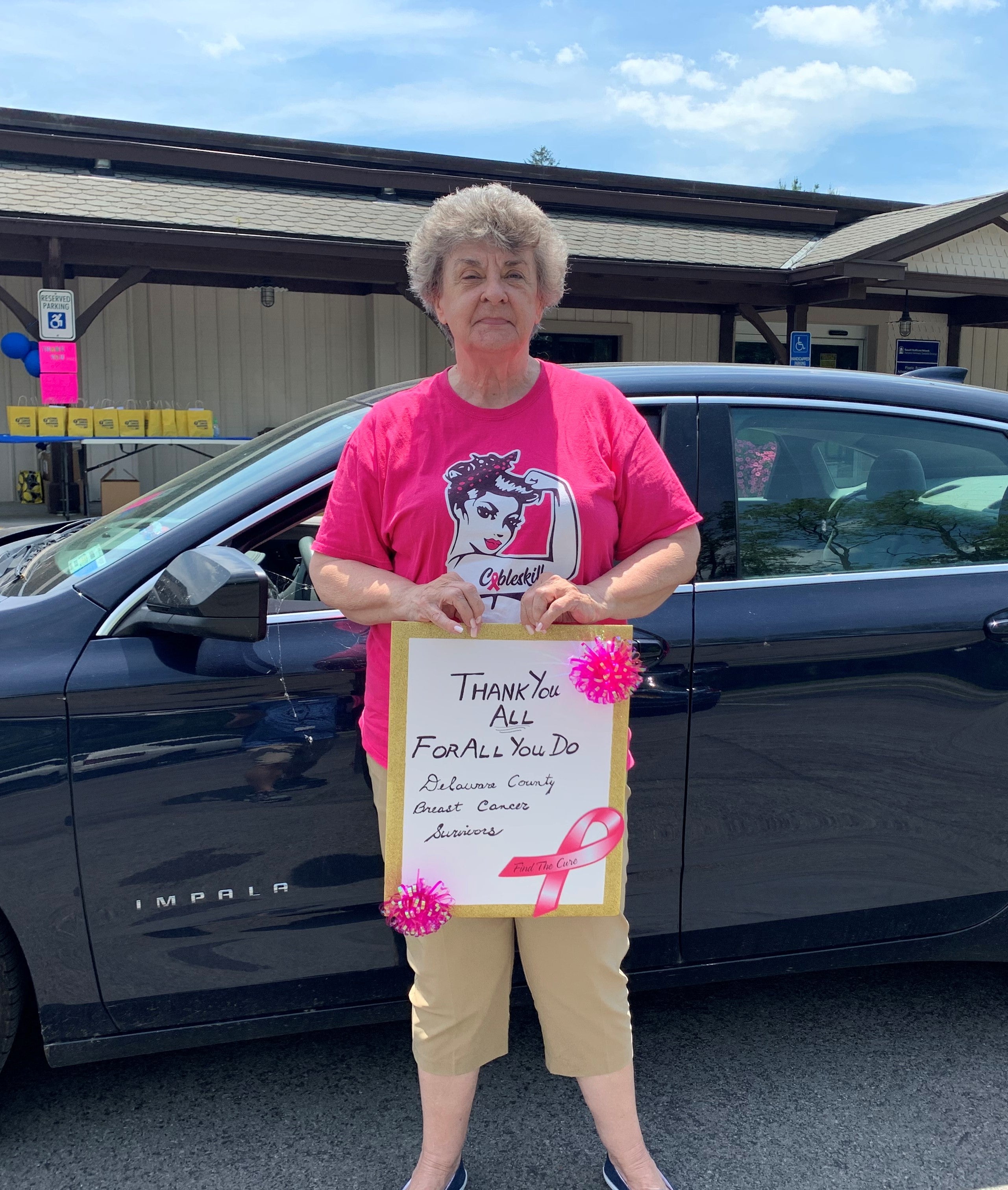Grateful patient with a thank you sign at event