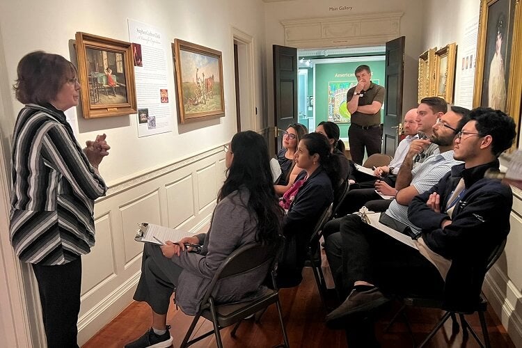 Residents observing a painting and discussing it with Laura Wetzel