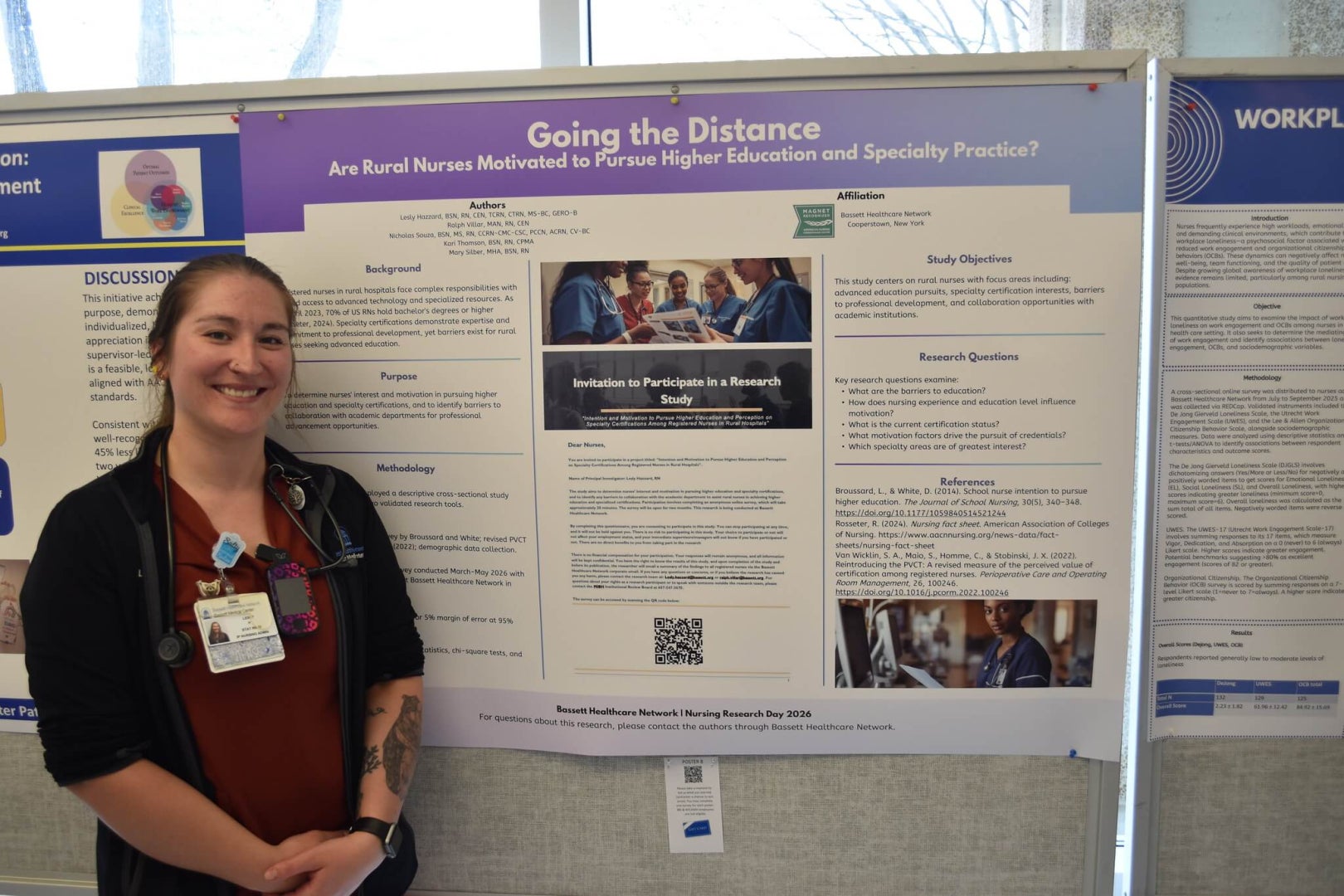 A woman stands next to a poster showcasing her research on rural nursing