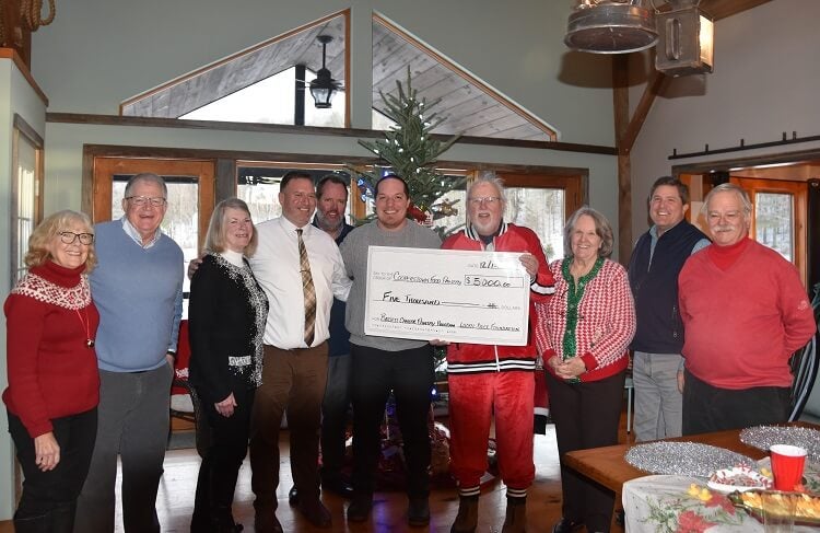 Members of the Lucky Duck Foundation present a ceremonial check to representatives of Bassett Cancer Institute and Cooperstown Food Pantry at a holiday celebration