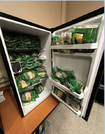 A mini refrigerator is full of food.