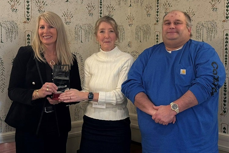Tonya Van Slyke of the Northeast Dairy Producers Association (left) receives the 2024 Hero Award from NYCAMH Director Dr. Julie Sorensen and ROPS Hotline Coordinator Duane Martin.