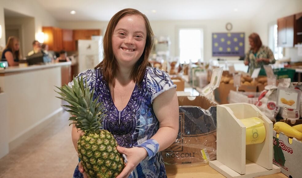 A Pathfinder Village resident shopping at Pathfinder Produce